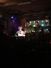 a group of people sitting at a table in a dark room